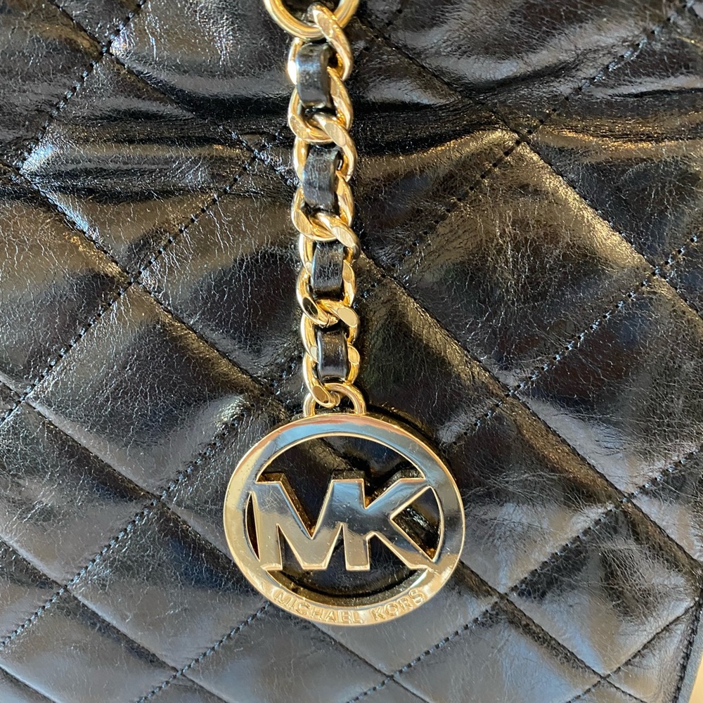 Beautiful Michael Kors soft, quilted black with gold hardware shoulder bag.